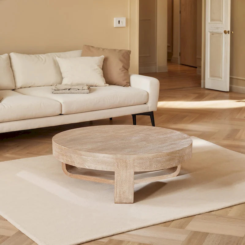 Table basse ronde en bois de manguier avec base ouverte en forme de traîneau